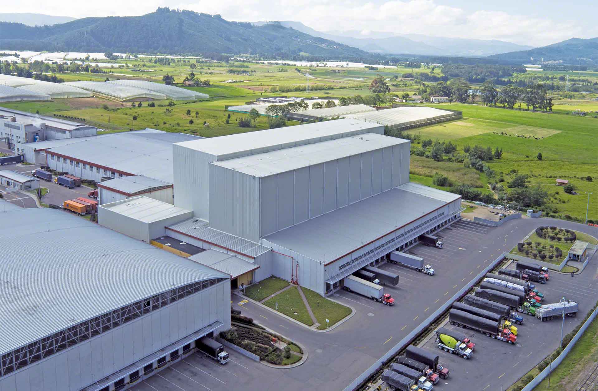 Aerial view of a logistics warehouse with loading docks and freight trucks
